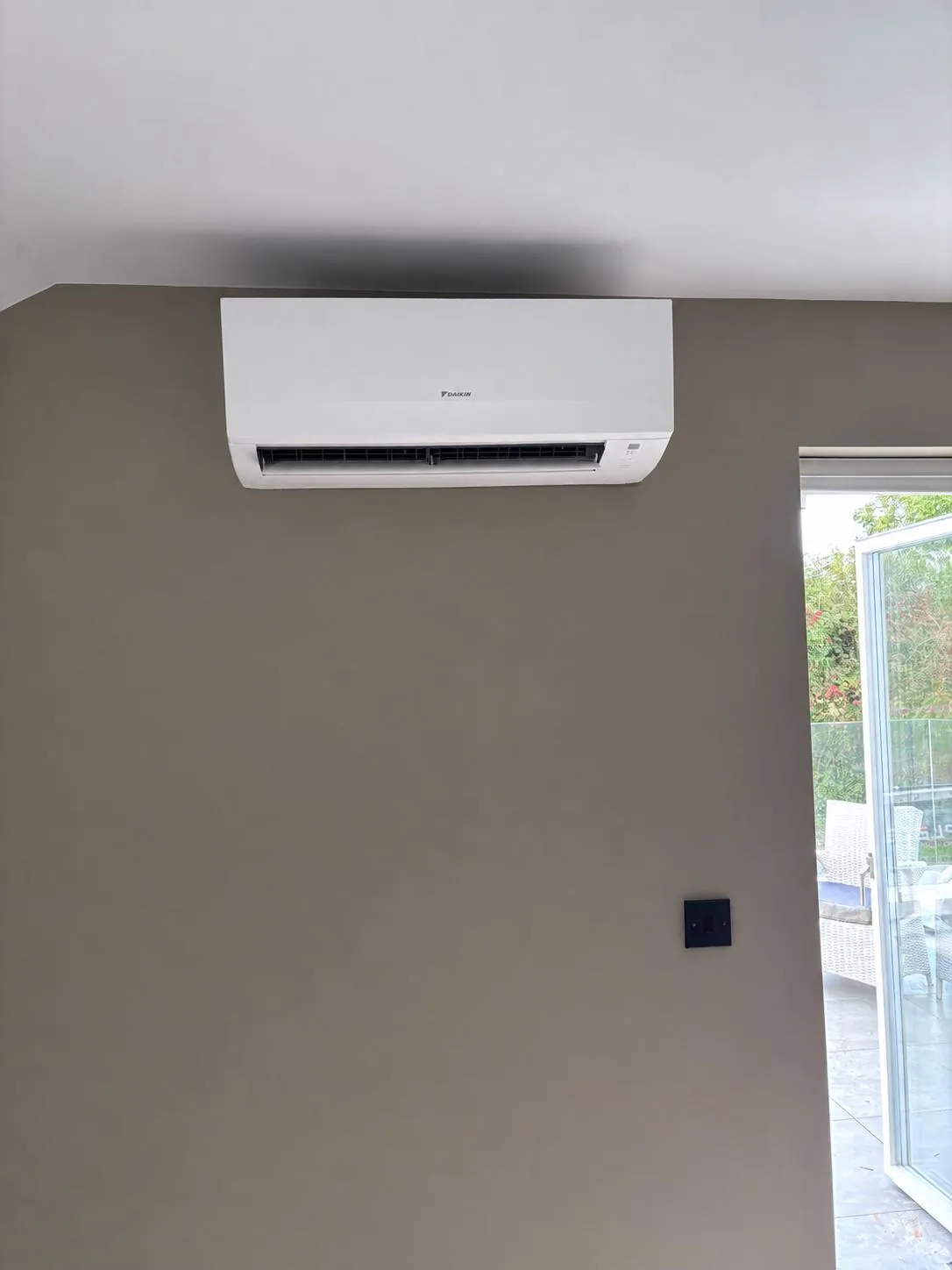 Daikin wall-mounted air conditioner installed high on a wall in a Cork home